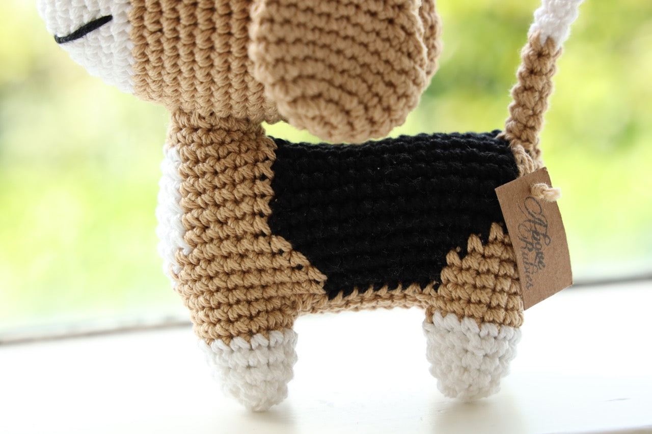 Close up view of a crocheted beagle toy with floppy ears